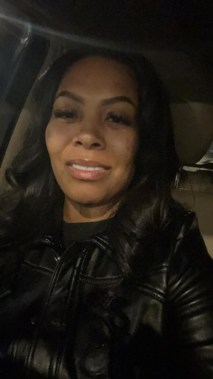 Kristen Sardin - Owner, Upfront Trans Photo of Kristen Sardin, owner of Upfront Trans, smiling and posing in front of a transport vehicle